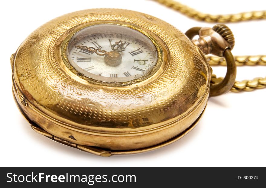 Macro shot of an aged golden pocket watch with chain. Macro shot of an aged golden pocket watch with chain.