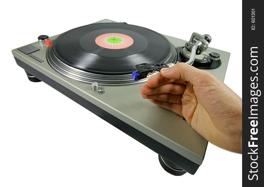 A hand putting a needle on a record. A hand putting a needle on a record