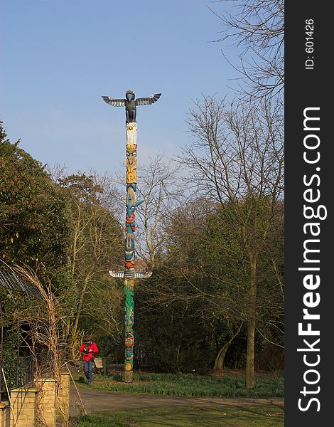 Photographer with totem pole on sunny day in park