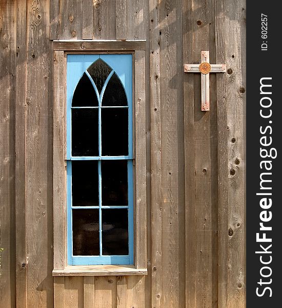 Blue church window and cross