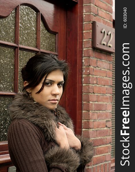 Beautiful Fashion Model posing in front of a brick house. Beautiful Fashion Model posing in front of a brick house