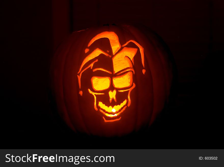 A jester carved from a pumpkin. A jester carved from a pumpkin