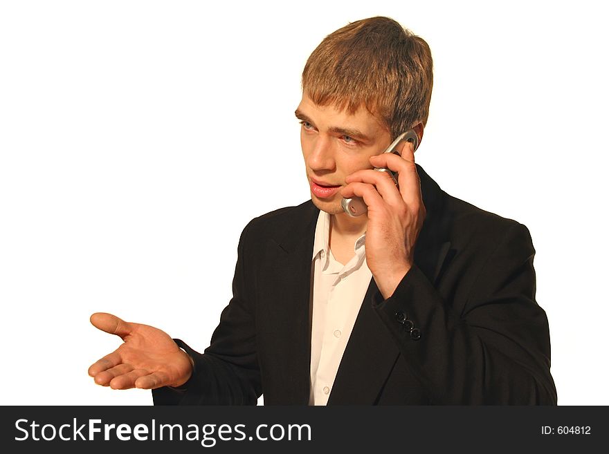 Young businessman in black suit arguing on his cell phone and gesticulating with his hand. Young businessman in black suit arguing on his cell phone and gesticulating with his hand