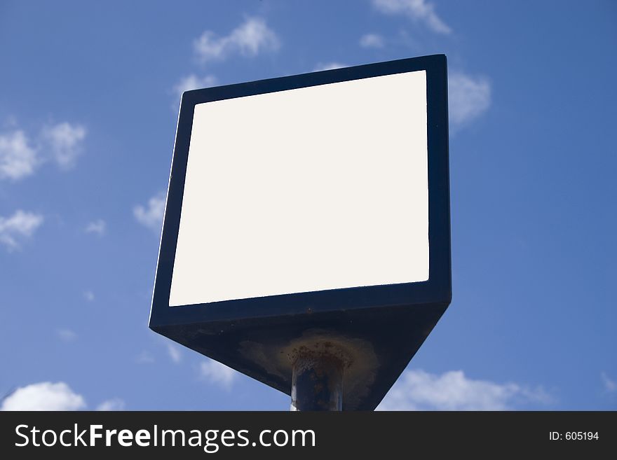 Photo of a blank billboard on a blue sky background.