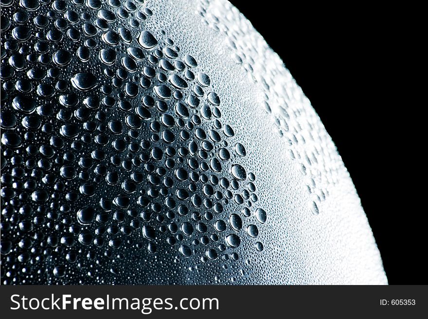 A creative shot taken of a water bottle with condensation on the inside featuring its smooth surface. A creative shot taken of a water bottle with condensation on the inside featuring its smooth surface