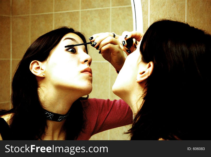 A girl applying mascara. A girl applying mascara