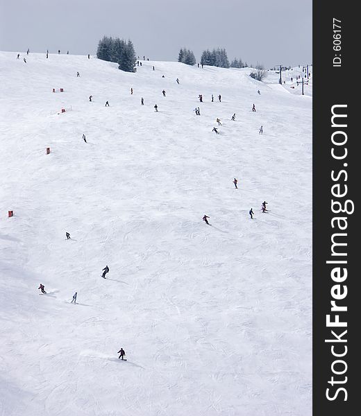 Skiers on downhill slope