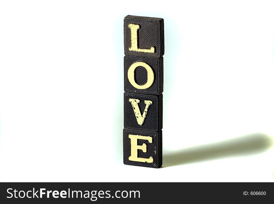 Love spelled in scrabble letters stacked on top of each other. Love spelled in scrabble letters stacked on top of each other.