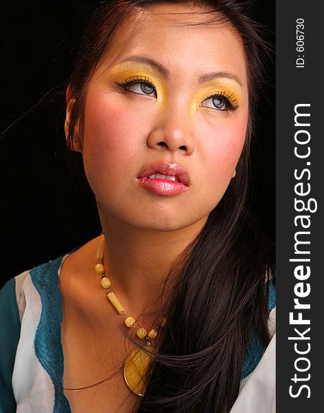 Pensive Asian with golden eyes. Pensive Asian with golden eyes
