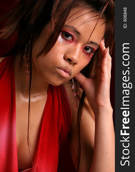 Asian model with red and finger on head. Asian model with red and finger on head