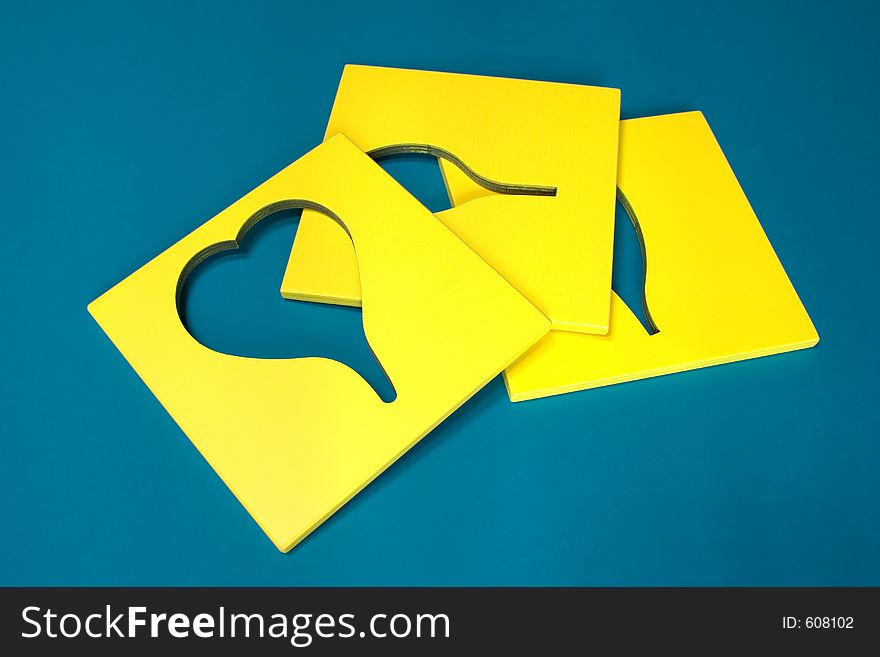 Yellow wooden shapes on green background. Canon EOS 20D ISO100. Yellow wooden shapes on green background. Canon EOS 20D ISO100