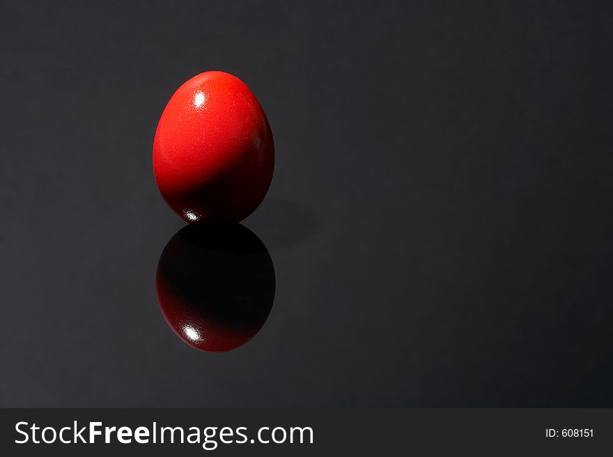 Red egg on black background. Red egg on black background