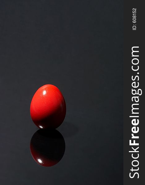 Red egg on black background. Red egg on black background