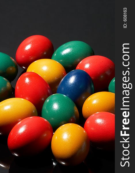 Many coloured eggs on black background. Many coloured eggs on black background