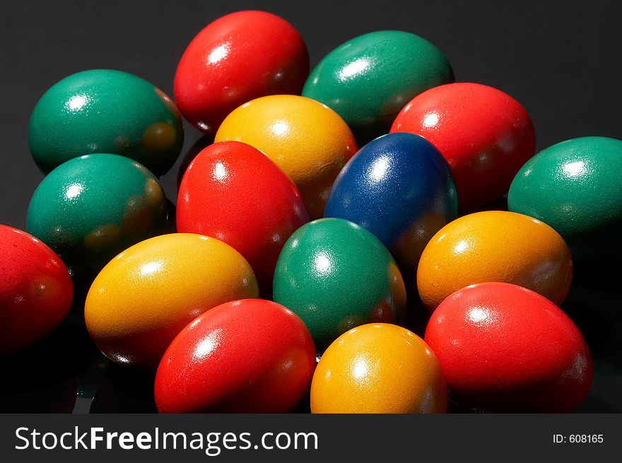 Many coloured eggs on black background. Many coloured eggs on black background