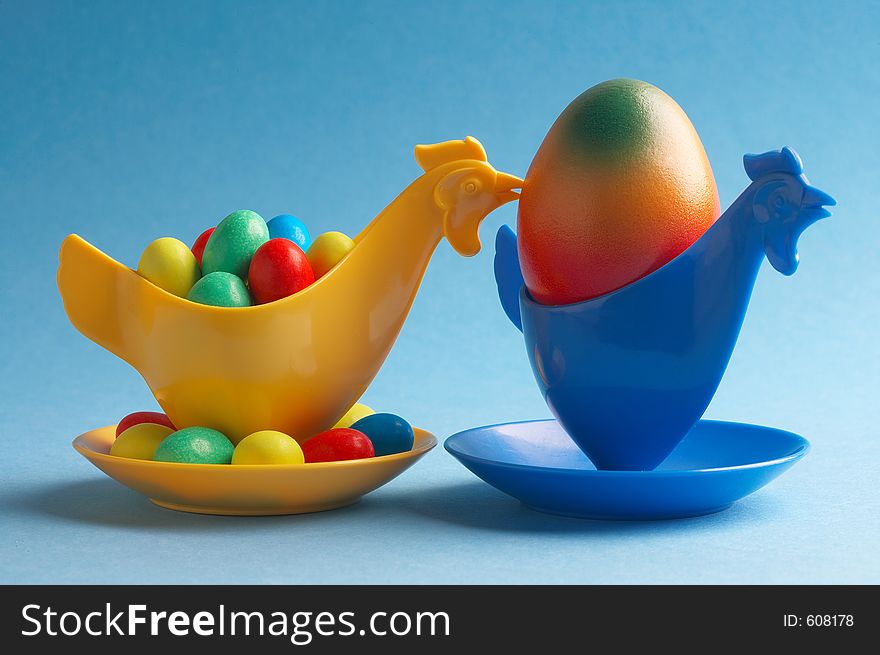 Yellow eggcup behind blue eggcup. Yellow eggcup behind blue eggcup