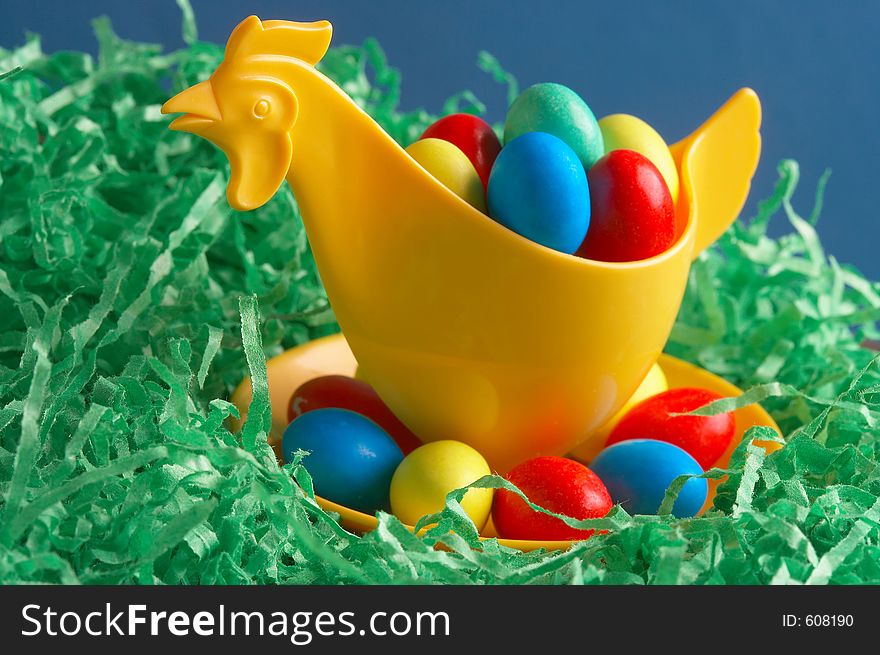 Yellow plastic- chicken in a easter basket. Yellow plastic- chicken in a easter basket