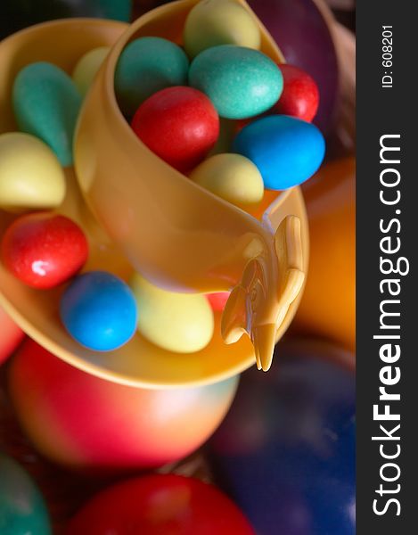Choco eggs in a eggcup on coloured eggs. Choco eggs in a eggcup on coloured eggs