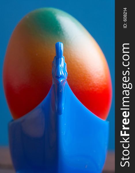 Blue eggcup chicken formed with a coloured egg in it. Blue eggcup chicken formed with a coloured egg in it