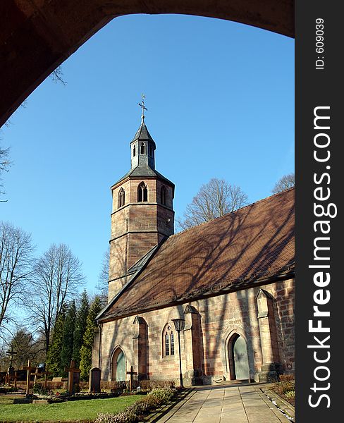 A view of Labach church in the Palatinate area of Germany as seen from the lychgate entrance of the churchyard.