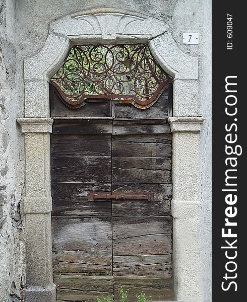 This very old door leading into a spacious park can be found on the island of Orta in the northern part of Italy in the Lago Maggiore region. This very old door leading into a spacious park can be found on the island of Orta in the northern part of Italy in the Lago Maggiore region