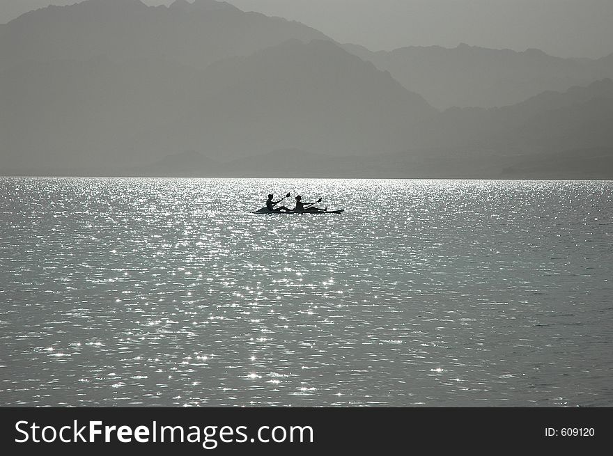 Canoe boat on the sunny surface of the sea. Canoe boat on the sunny surface of the sea