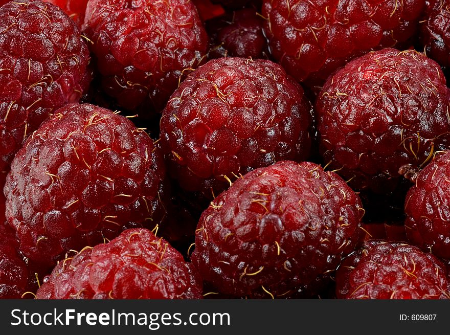 Pile of red luscious raspberries - macro. Pile of red luscious raspberries - macro