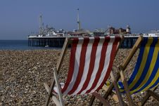 Pair Of Deck Chairs Facing Out At Brighton Pier Stock Photos