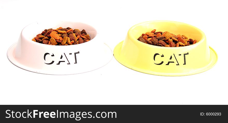 Shot of two cats feeding bowls with biscuits in. Shot of two cats feeding bowls with biscuits in