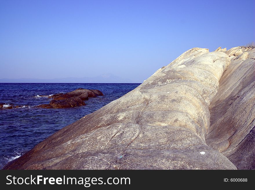 Rock on the shore with decent blue sea