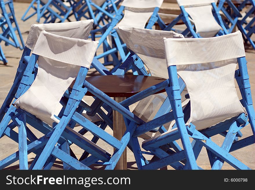 Blue chairs on the sun