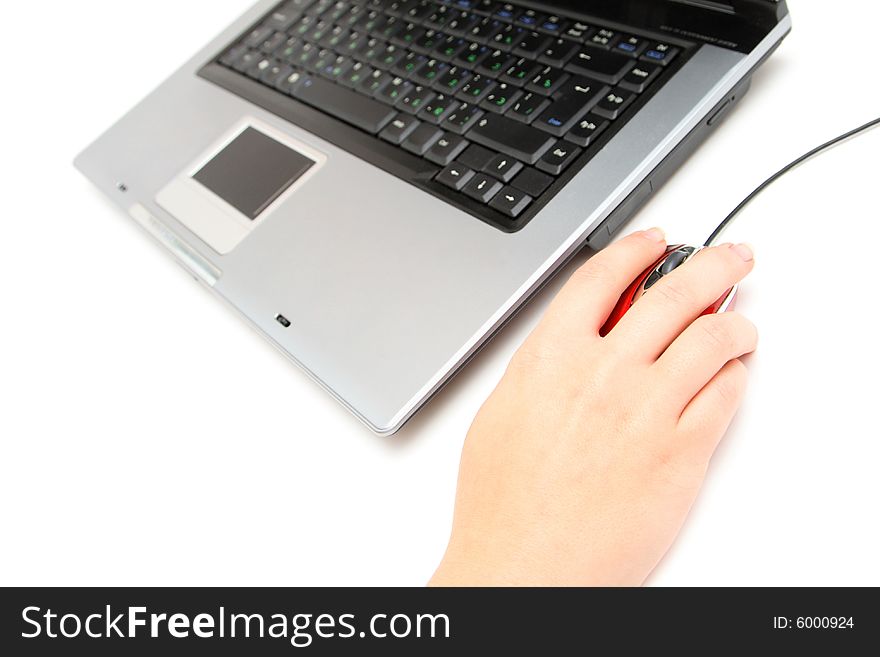 Female hand on mouse with notebook. Female hand on mouse with notebook