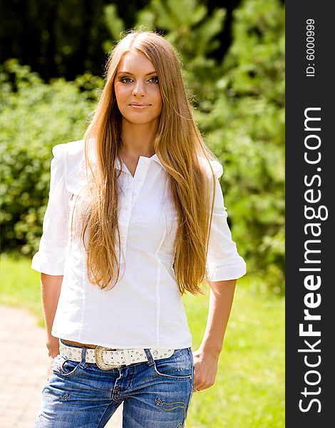 Portrait of lovely young woman in summer park