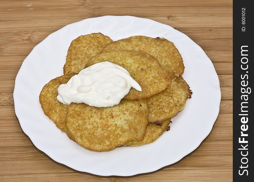 Traditional delicious potato pancakes served with sour cream