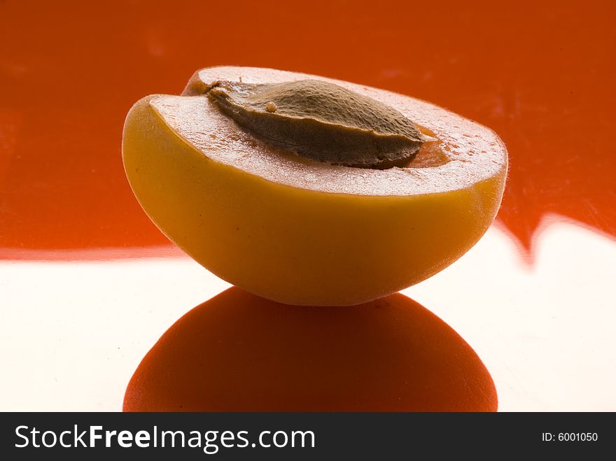 Apricot slice on a reflecting surface