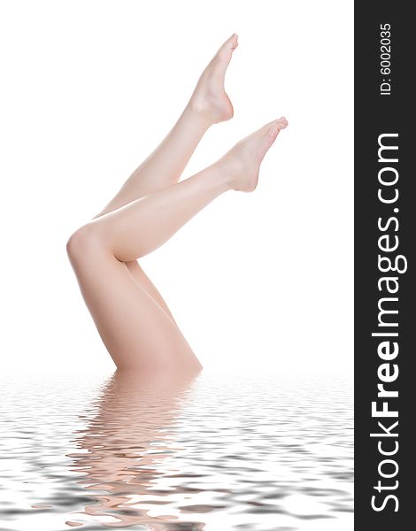 Female legs lifted above water. Female legs lifted above water