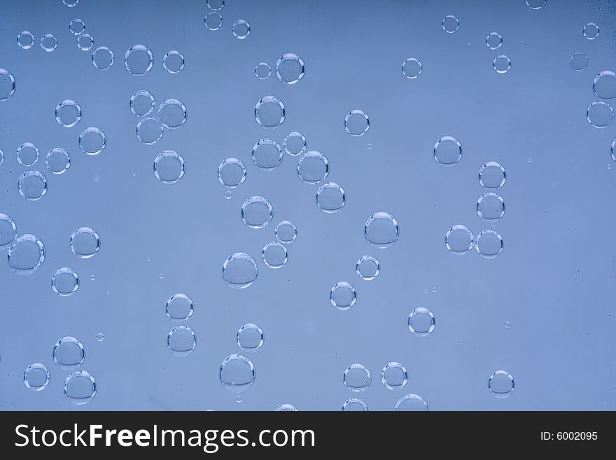 Drops of water on a blue background. Drops of water on a blue background