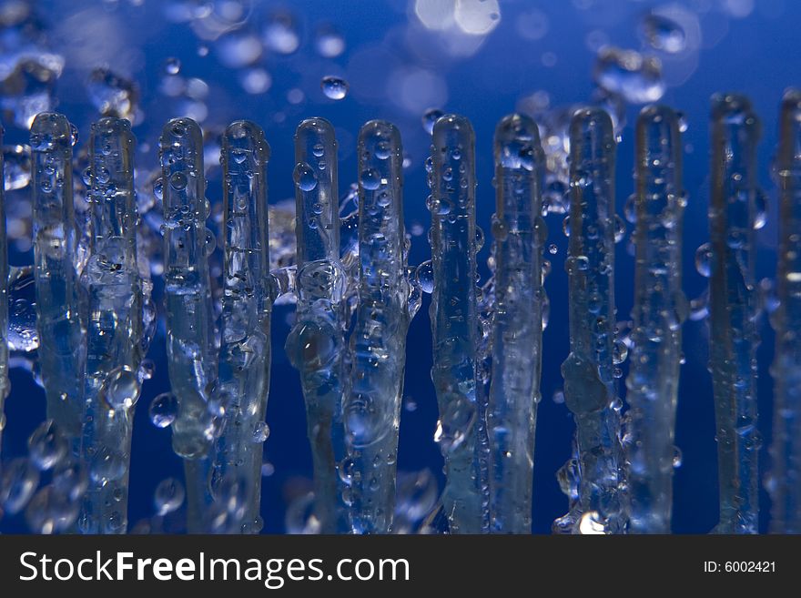 Ice and water drops on the blue background