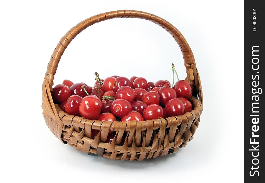 Cherries in a basket  isolated on white background.
