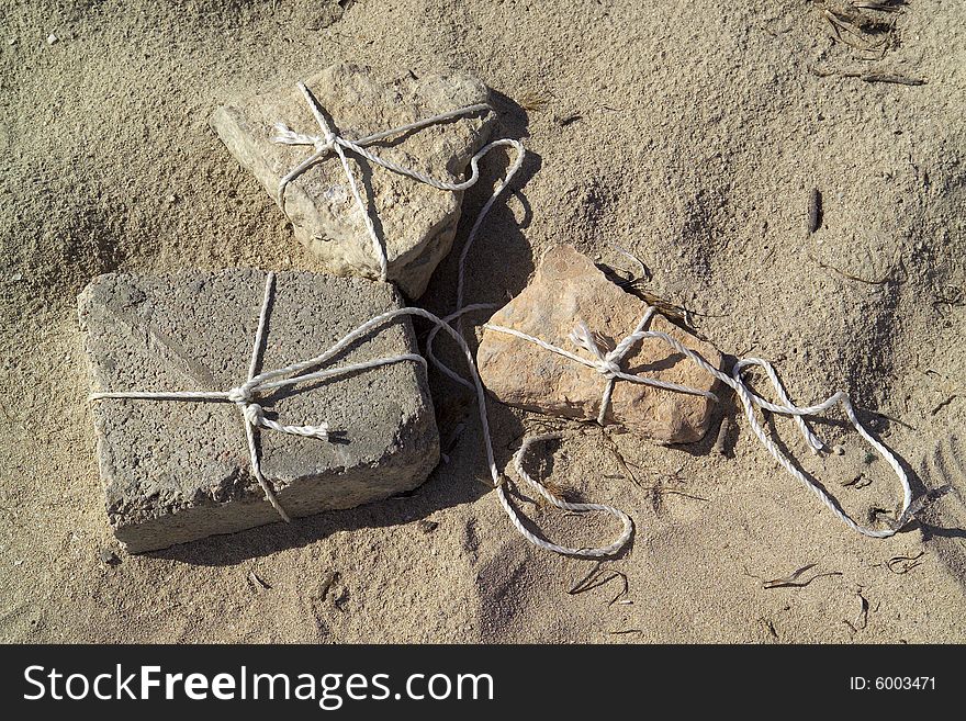 Linked stones on a sand background