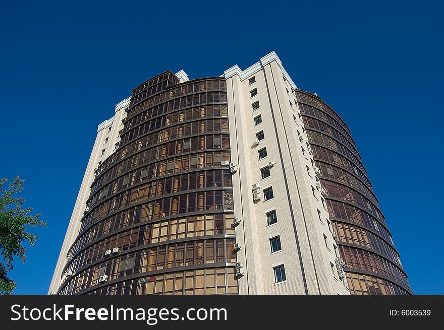 High modern office building with blue sky background