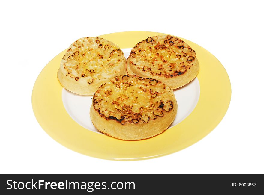 Three crumpets on a plate