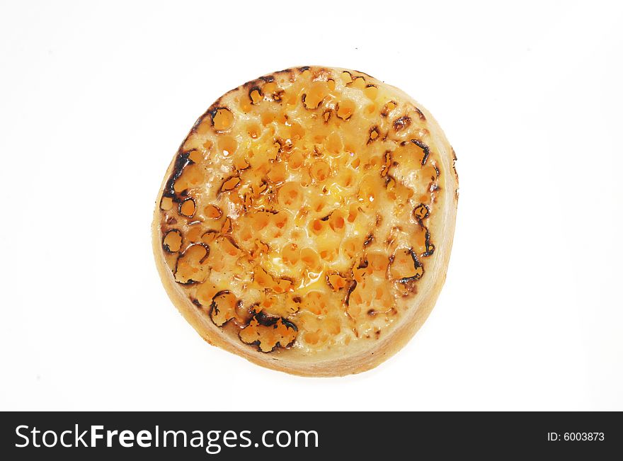 Toasted and buttered crumpet isolated on white