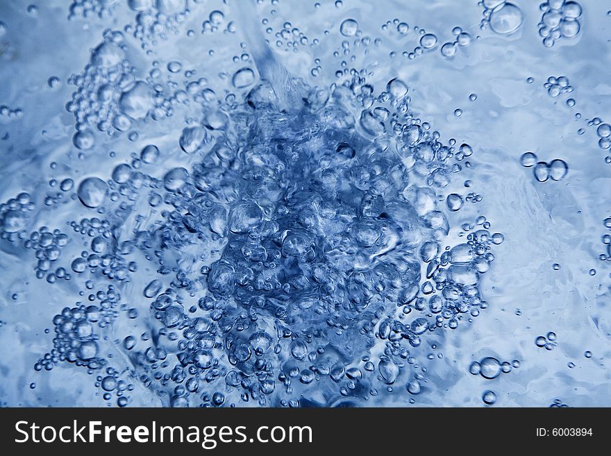 A close up view of a stream of water as it is being poured. A close up view of a stream of water as it is being poured.