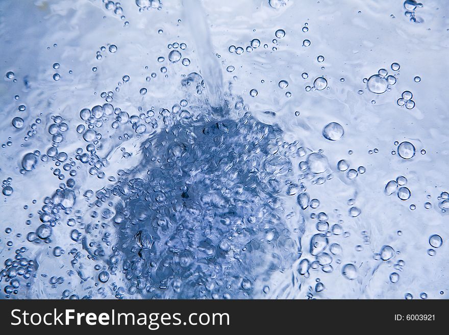 A close up view of a stream of water as it is being poured. A close up view of a stream of water as it is being poured.