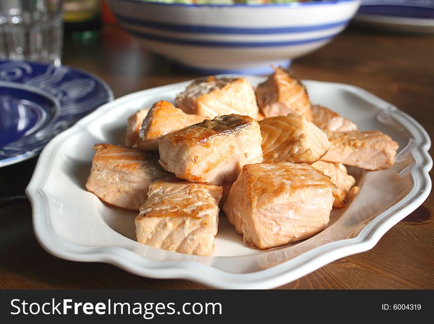 Salmon pieces on a white plate