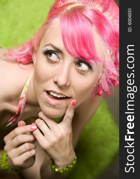 Closeup of Pretty Woman with Pink Hair on Green Rug