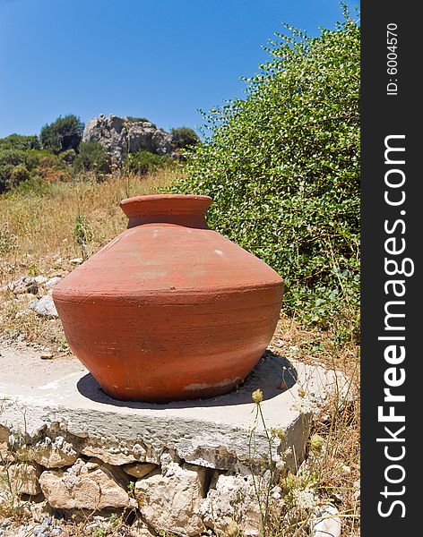 Old greek clay vase staying outdoor on stone. Samos Island, Greece. Old greek clay vase staying outdoor on stone. Samos Island, Greece.