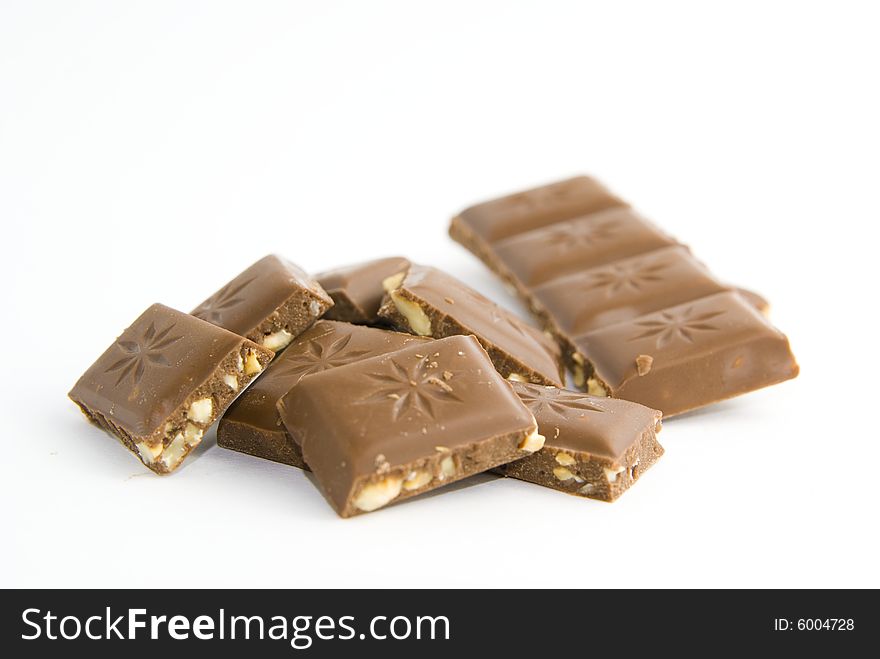 Milk chocolate with nuts on white background. Milk chocolate with nuts on white background