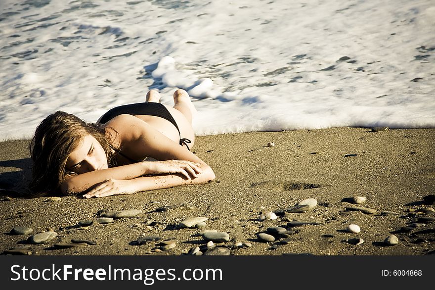 Green eyed beauty laying over the sand. Green eyed beauty laying over the sand